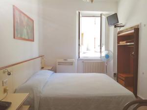 - une chambre avec un lit blanc et une fenêtre dans l'établissement Hotel Boston, à Milan