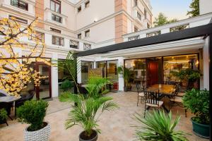 an outdoor patio with a table and chairs and plants at Urban Boutique Hotel in Tbilisi City