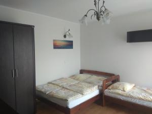 Postel nebo postele na pokoji v ubytování Willa Arkadia