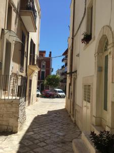 Une allée dans une ville avec des bâtiments et des voitures dans l'établissement LA CASETTA 6058, à Conversano