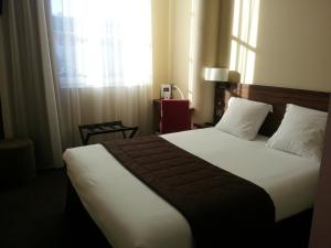 Postel nebo postele na pokoji v ubytování Hotel Vauban
