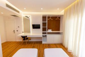 a living room with a desk and a tv at Inada Hotel Ksamil in Ksamil