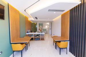 a dining room with wooden tables and yellow chairs at Inada Hotel Ksamil in Ksamil +29 photos
