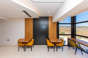 a meeting room with desks and chairs and windows at Inada Hotel Ksamil in Ksamil