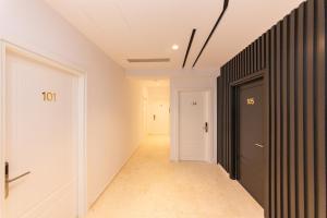 a hallway with a black and white door and a hallway at Inada Hotel Ksamil in Ksamil