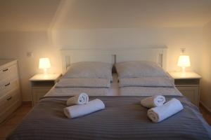 a bedroom with two beds with towels on them at Villa Kiki in Rovinj