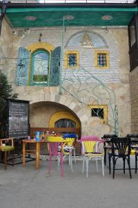 a group of tables and chairs in front of a building at Apartman Tuareg in Sarajevo