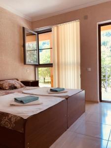 a large bedroom with two beds with towels on them at Teremok Guest House in Lidzava