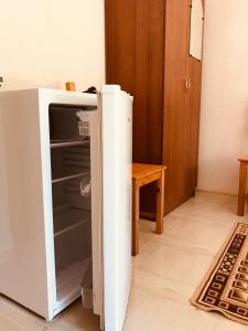 a refrigerator with its door open in a room at Teremok Guest House in Lidzava