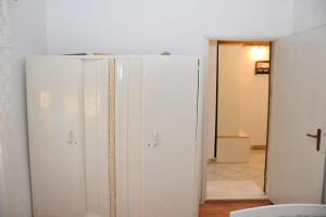 a white cabinet in a room with a mirror at Velebit in Ražanac +31 photos