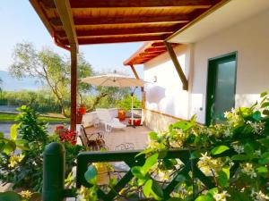 a patio of a house with an umbrella at B&B Maison Villa Vittorio in Avella