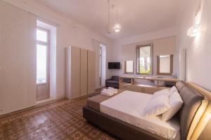 a large bedroom with a bed and a couch at Villa Dea in Grottaglie