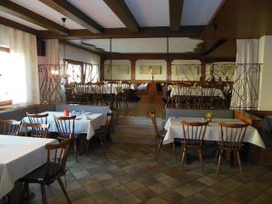 a restaurant with tables and chairs in a room at Grüner Baum in Stetten