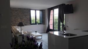 a kitchen and living room with a couch and windows at Mirador del Cantabrico in Lastres