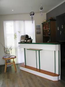 a counter in a room with a table at Pension Dünenhaus in Zempin