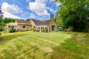 a house with a large lawn in front of it at Fernbank Suite in Sheffield