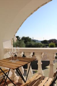a table with wine glasses on a balcony at Villa Kiki in Rovinj