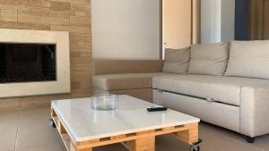 a living room with a couch and a coffee table at Niovi Boutique Apartments in Afitos