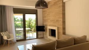 a living room with a couch and a fireplace at Niovi Boutique Apartments in Afitos