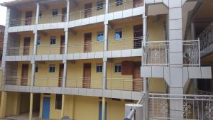a building with balconies on the side of it at Hotel Dot Com Entebbe in Entebbe