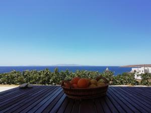 un cesto di frutta seduto sopra un tavolo di SUN AND SEA COTTAGE a Città di Tinos