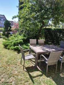 a picnic table and chairs in a yard at Oliwier in Rewal