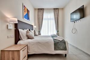 Posteľ alebo postele v izbe v ubytovaní The Suites – Piazza Kirkop