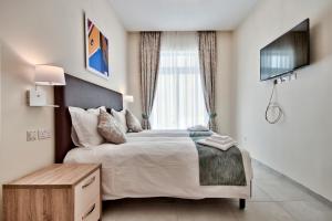 TV a/nebo společenská místnost v ubytování The Suites – Piazza Kirkop