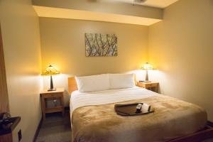 a bedroom with a bed with a tray on it at Echo Bluff State Park Lodge and Cabins in Eminence