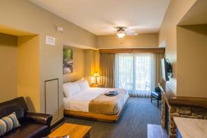 a hotel room with a bed and a television at Echo Bluff State Park Lodge and Cabins in Eminence +66 photos