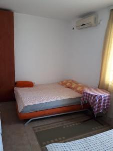 a small bed in a room with a window at Vila Stojana in Sutomore