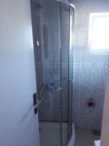 a shower with a glass door in a bathroom at Vila Stojana in Sutomore