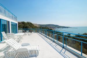 a balcony with chairs and a view of the water at Hotel Iceberg in Balchik