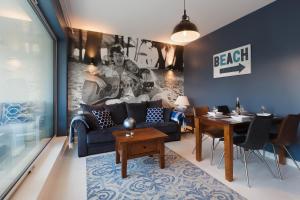 a living room with a couch and a table at Hothel in Hel
