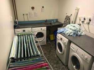 a laundry room with a washing machine and a drying rack at Steiner's Camping & Lodge in Johannisholm