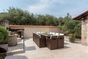 a patio with a table and chairs in a backyard at Villa Sunshine in Pula
