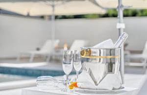 a table with wine glasses and a bucket on it at Hotel Trogirski Dvori in Trogir
