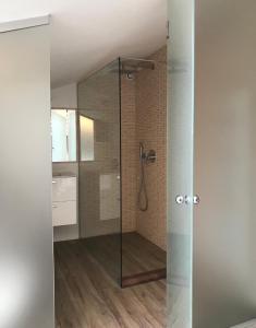 a bathroom with a shower with a glass door at B&B "al Pesce Vela" in Albese Con Cassano