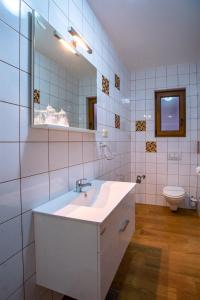 a bathroom with a sink and a mirror and a toilet at Mare E Sabbia in Lopar +50 photos