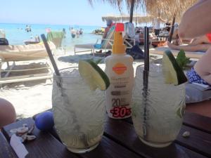 two drinks on a table at the beach at George apartments in Kallithea Halkidikis