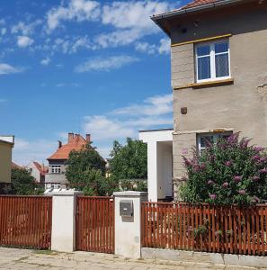 a house with a fence in front of it at Penzion Flóra in Žatec