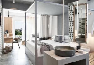 a bedroom with a bed and a sink in a room at Antigoni Seaside Resort in Ormos Panagias