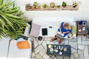 an overhead view of a woman sitting on a toilet with a laptop at Olive Hostel Lagos in Lagos