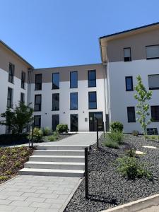 a large white building with stairs in front of it at Boutique Appartement @Park in Rheinhausen