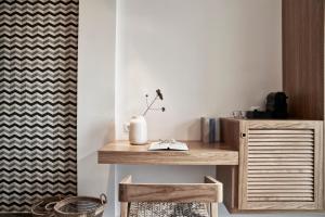 a wooden desk in a room with a curtain at Antigoni Seaside Resort in Ormos Panagias