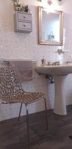 a bathroom with a sink and a chair and a mirror at Le Finestre di San Michele in Castiglion Fiorentino +51 photos