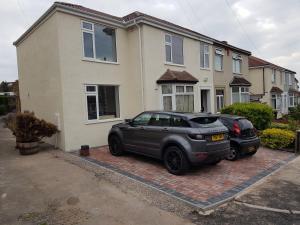 two cars parked in front of a house at The Whiteways in Bristol