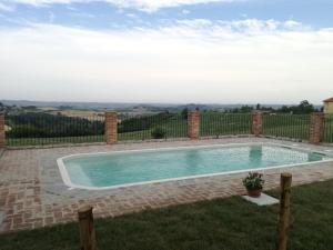 a swimming pool in the backyard of a house at Azienda Agricola Garoglio Davide in Alfiano Natta