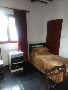 a bedroom with a bed and a dresser and a window at Ksa en la Linda in Salta