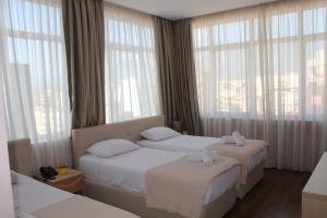 Postel nebo postele na pokoji v ubytování Signature Idea hotel
